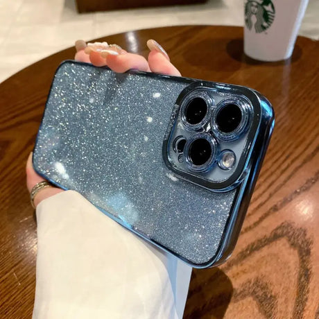 a woman holding a phone case with glitter on it