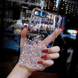 a woman holding a phone case with glitter