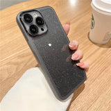 a woman holding a phone case with glitter on it