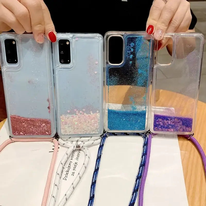 a woman holding a phone case with glitter