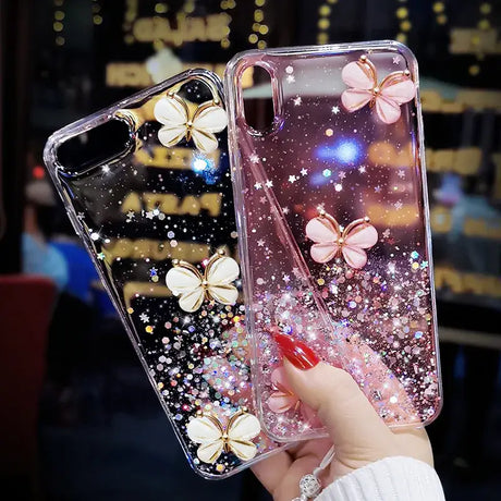 A woman holding a phone case with glitter butterflies