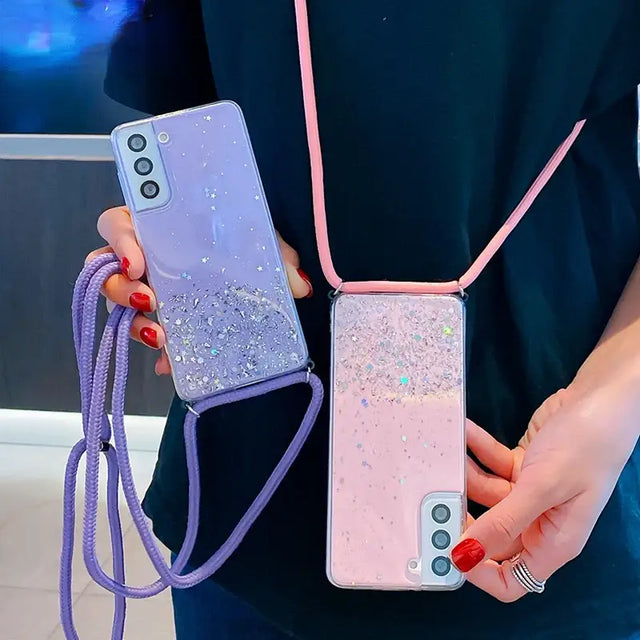 a woman holding a phone case with glitter