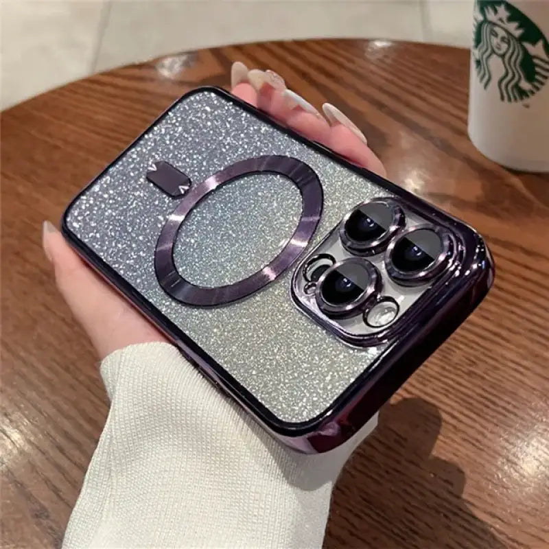 a woman holding a phone case with a glitter phone cover