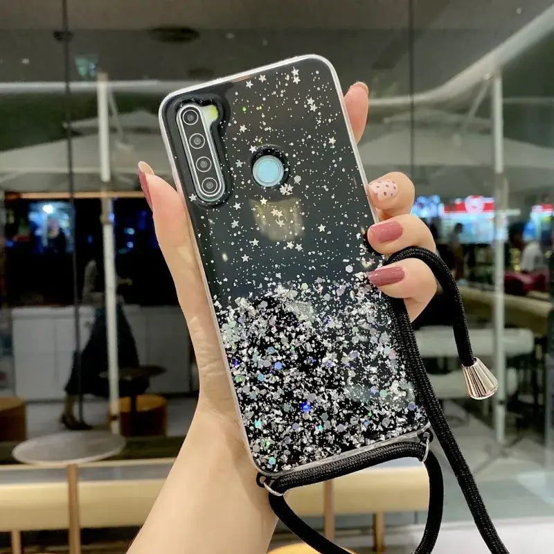 A woman holding a phone case with glitter stars on it