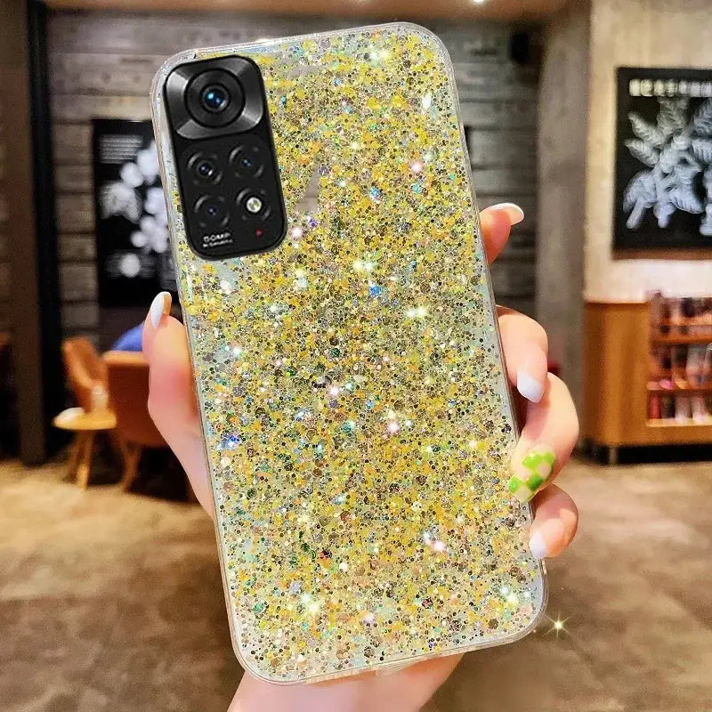 a woman holding a phone case with glitter