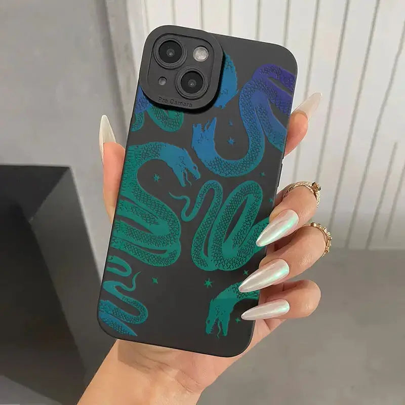 a woman holding a phone case with a green and blue pattern