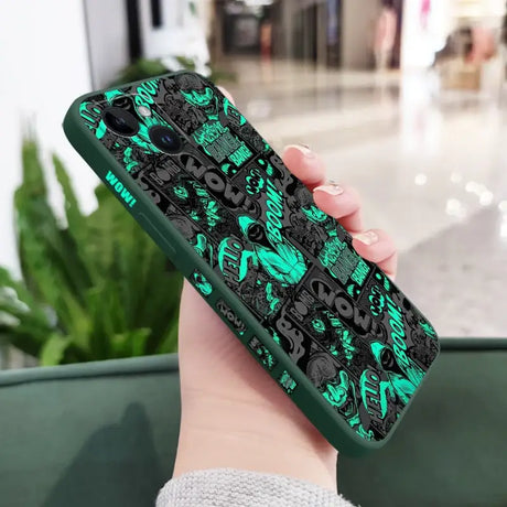 A woman holding a phone case with a green and black pattern