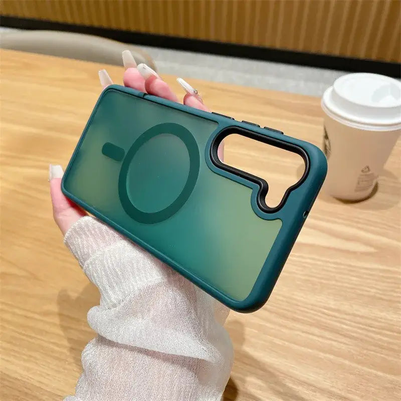 a woman holding a phone case with a green lens