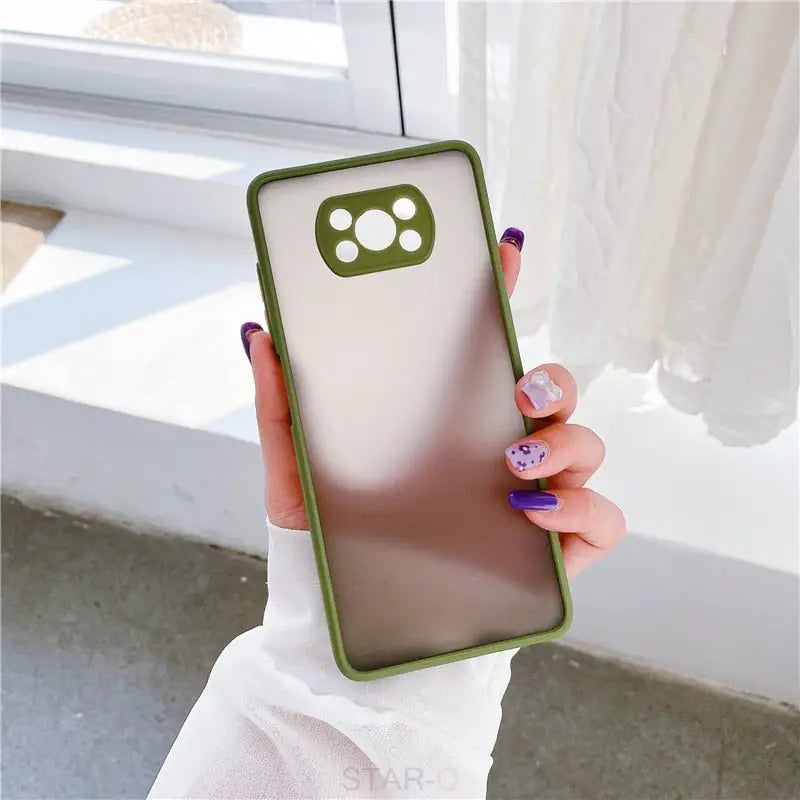 a woman holding a phone case with a green and white design
