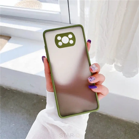 A woman holding a phone case with a green and white design