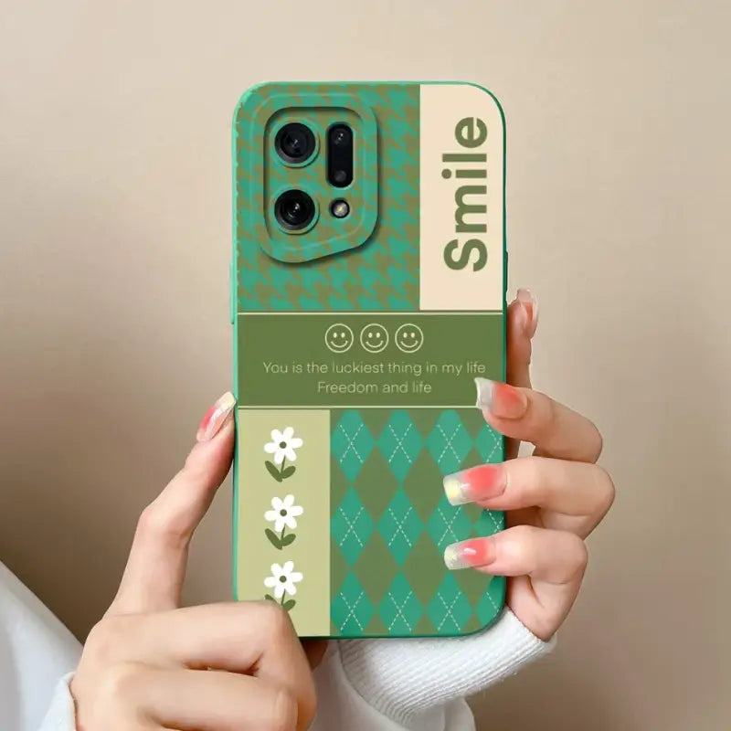 a woman holding a phone case with a green and white pattern