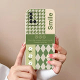 a woman holding a phone case with a green and white pattern