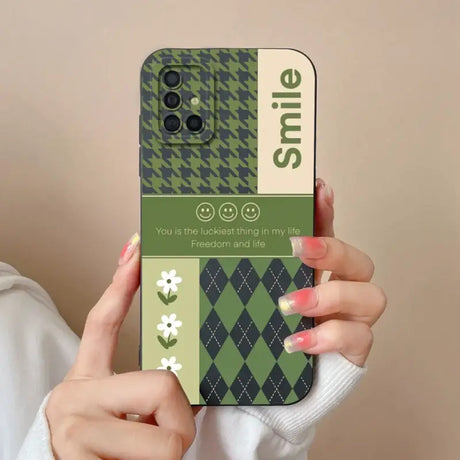 a woman holding a phone case with a green argyle pattern