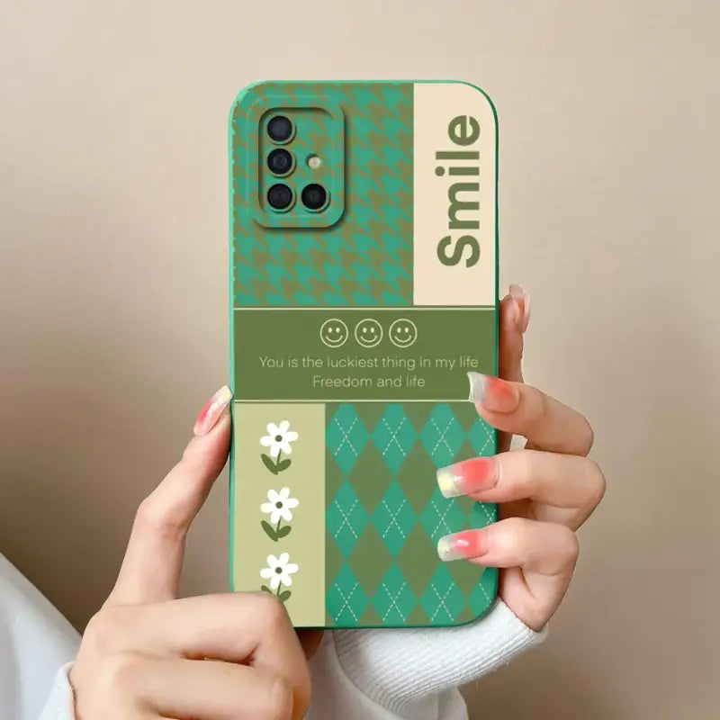 a woman holding a phone case with a green argyle pattern