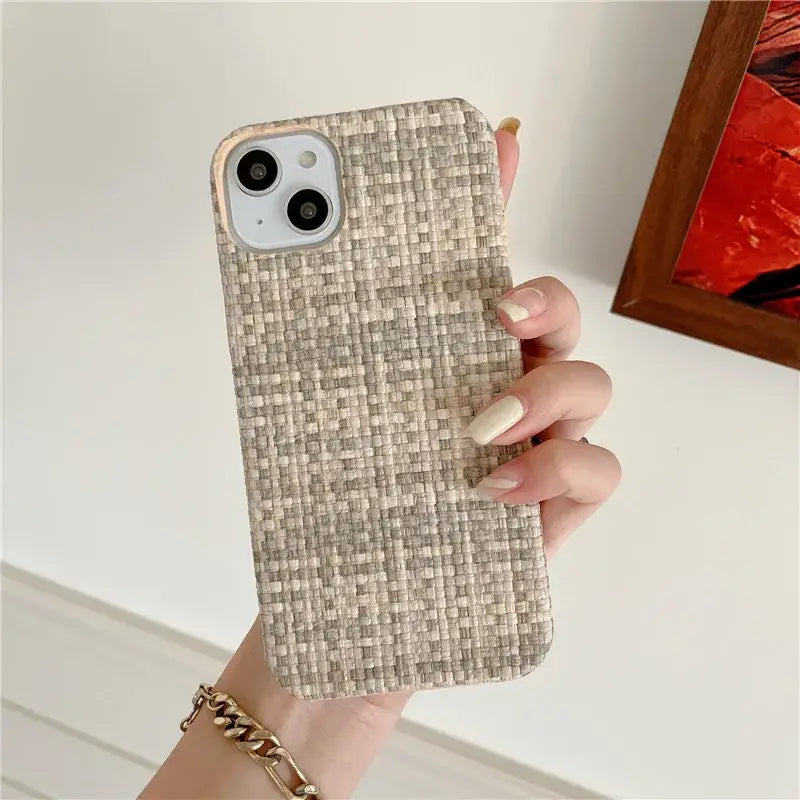 A woman holding a phone case in her hand