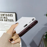 a woman holding a phone case in her hand