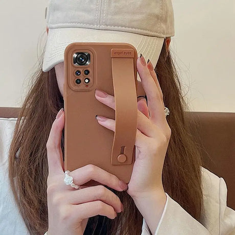 a woman holding a phone case in her hand