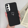 a woman holding a phone case with a heart on it