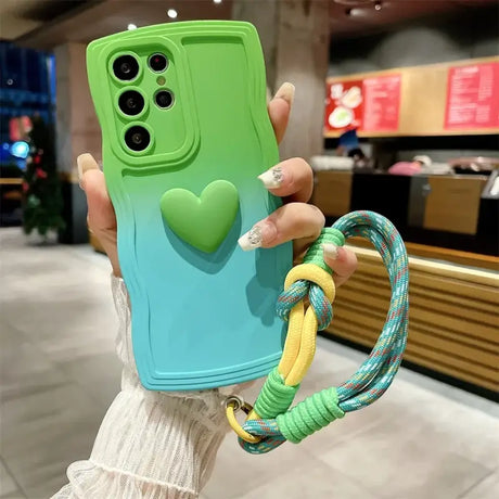 A woman holding a phone case with a heart on it