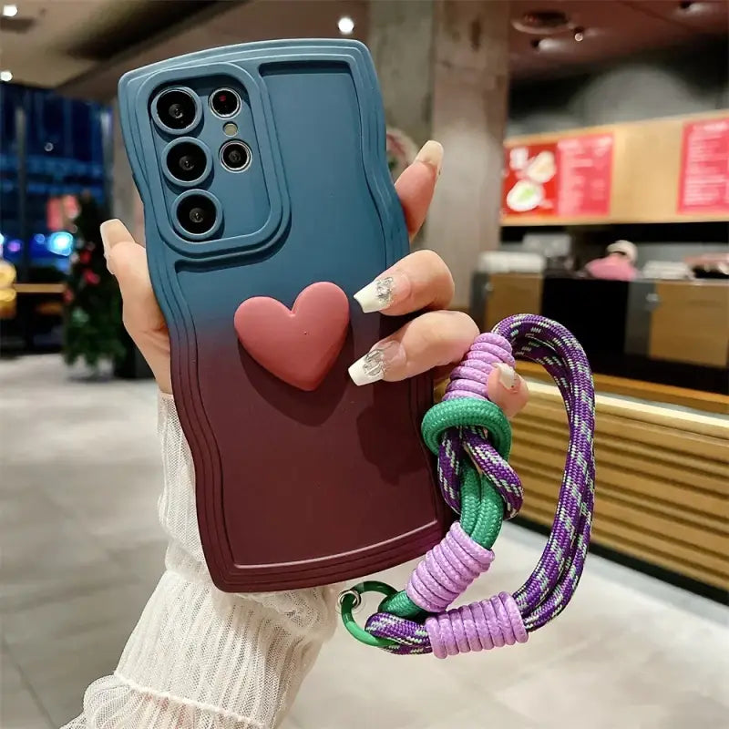 a woman holding a phone case with a heart on it