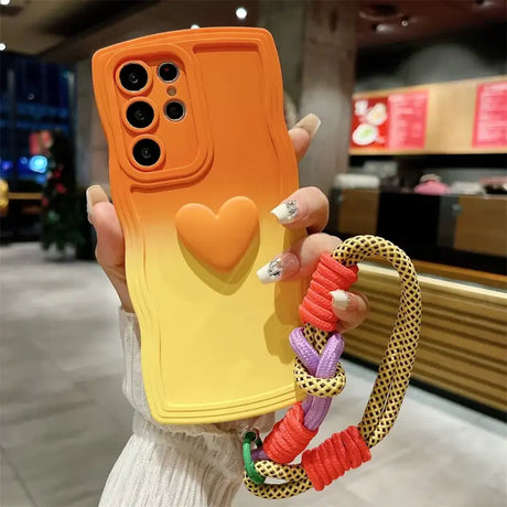 A woman holding a phone case with a heart on it