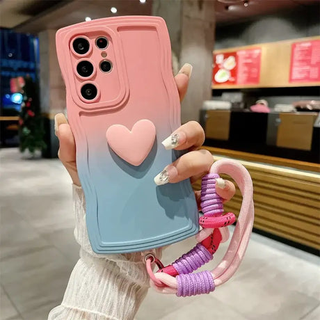 A woman holding a phone case with a heart on it