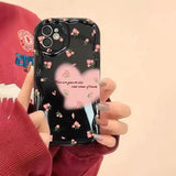 a woman holding a phone case with a heart design
