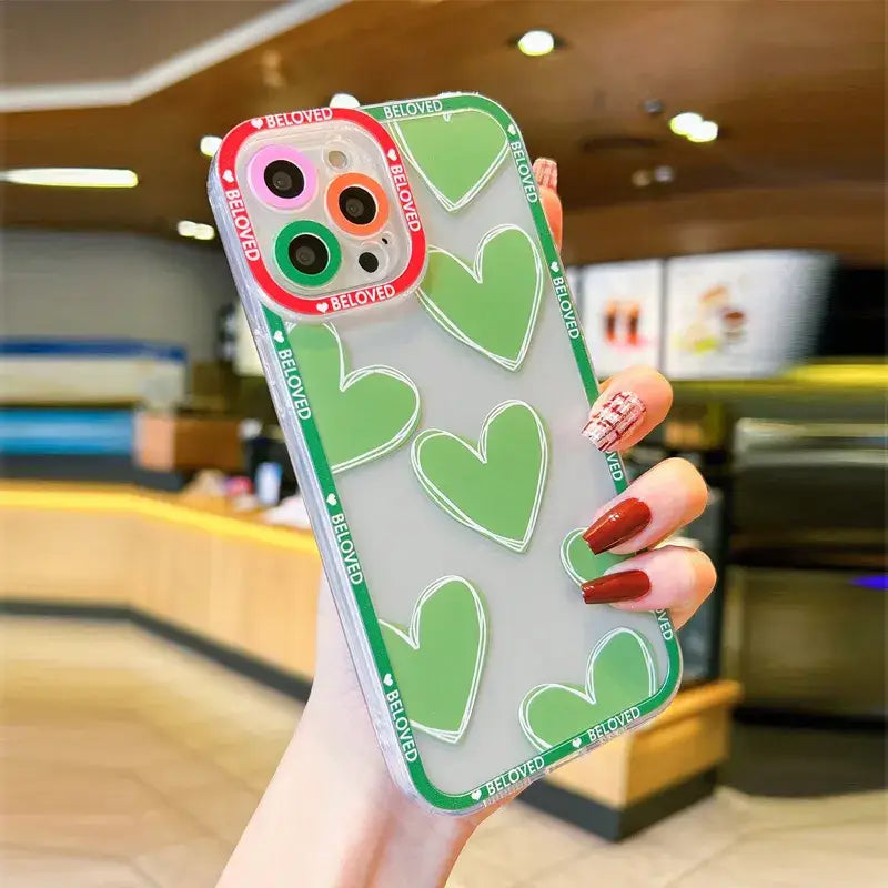 A woman holding a phone case with a heart pattern