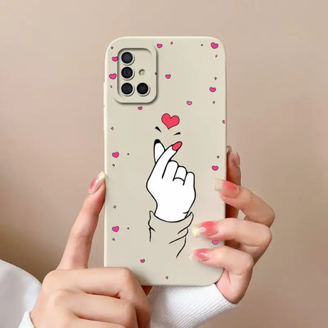 a woman holding a phone case with a heart on it