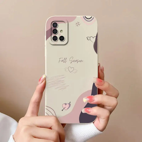 a woman holding a phone case with a heart design