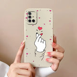 a woman holding a phone case with a heart on it