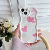 a woman holding a phone case with hearts on it