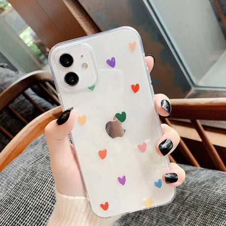 A woman holding a phone case with hearts on it