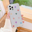 A woman holding a phone case with hearts on it