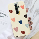 A woman holding a phone case with hearts on it