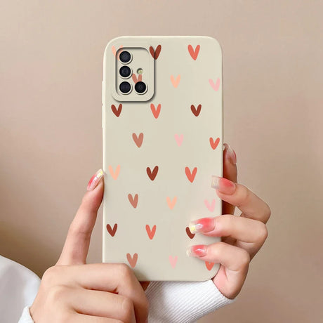 a woman holding a phone case with hearts on it