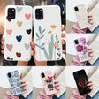 A woman holding a phone case with hearts and flowers