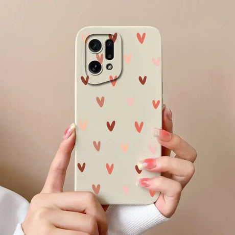 a woman holding a phone case with hearts on it