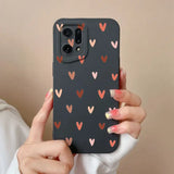 a woman holding a phone case with hearts on it