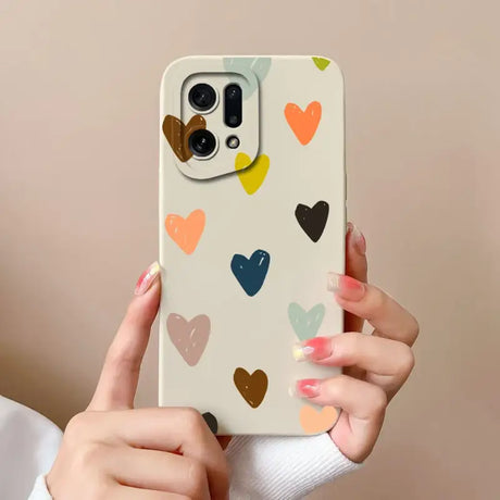 a woman holding a phone case with hearts on it