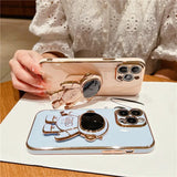 a woman holding a phone case with a phone holder
