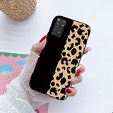 a woman holding a phone case with a leopard print