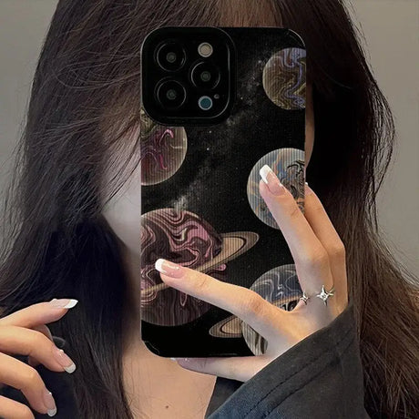 A woman holding up her phone case