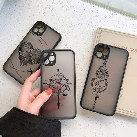 A woman holding a phone case with a drawing on it