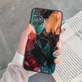a woman holding a phone case with a marble pattern