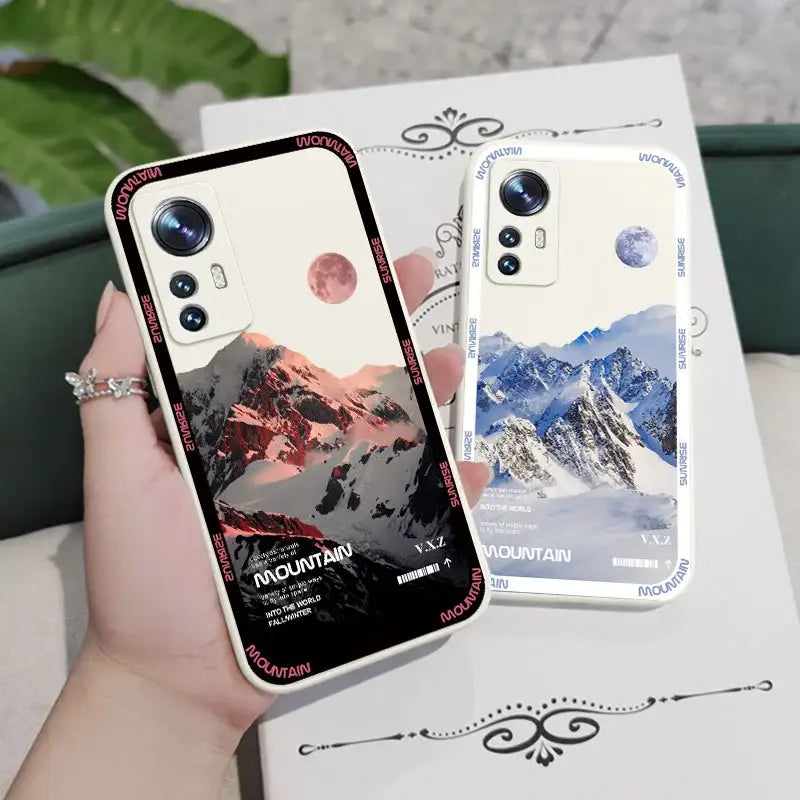 a woman holding a phone case with a mountain scene