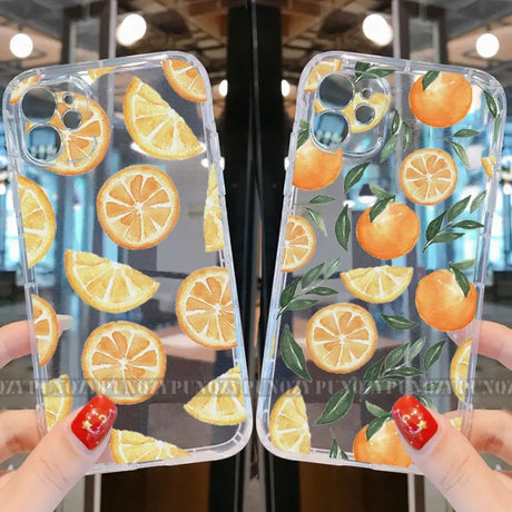 A woman holding up a phone case with oranges on it