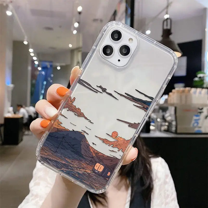 a woman holding up a phone case with a painting on it