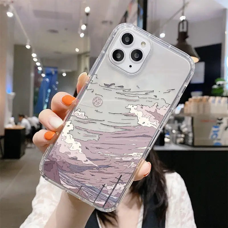 a woman holding up a phone case with a painting on it