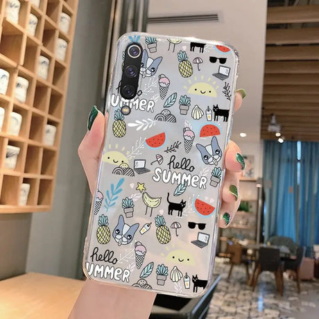 A woman holding up a phone case with a pattern of cats and dogs